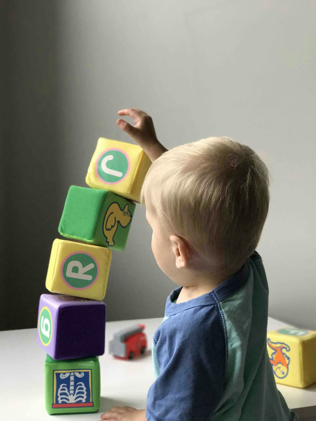Learning Center A toddler playing with colorful blocks